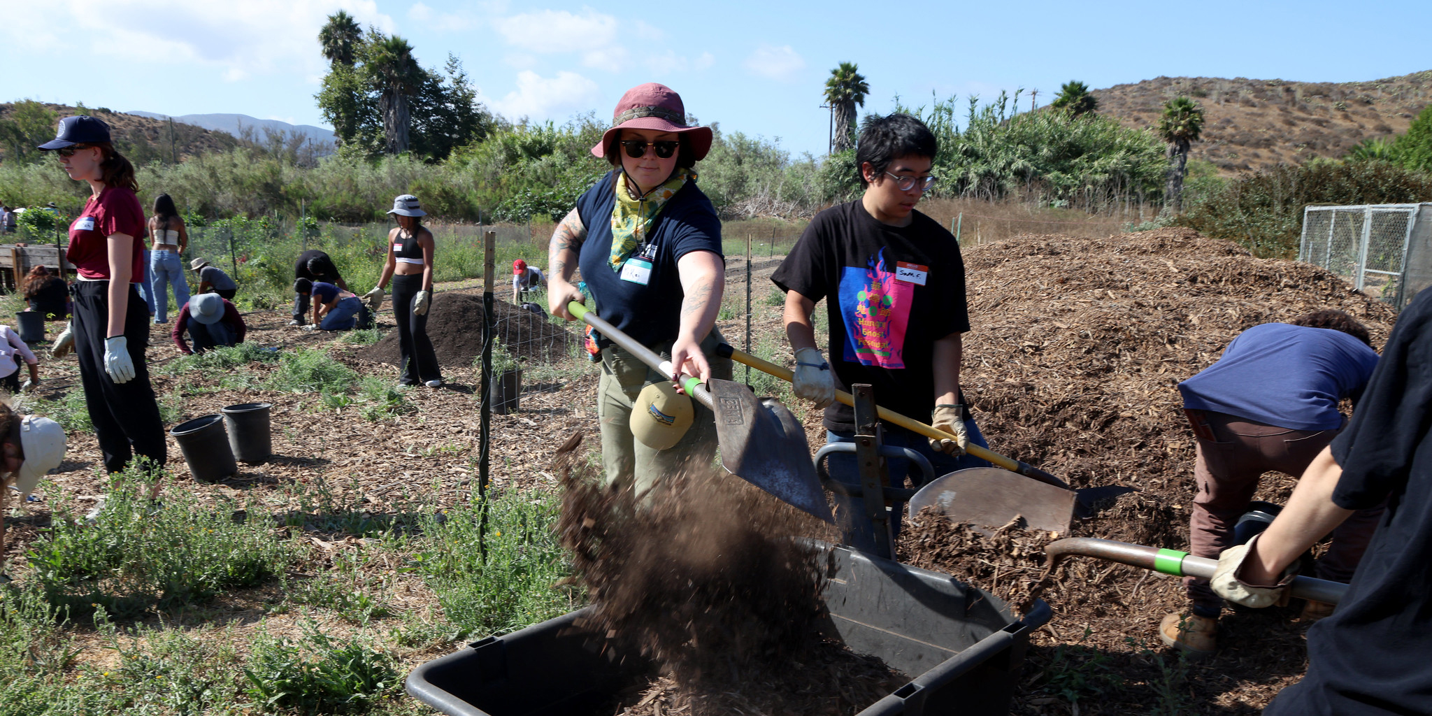 Moving Mulch - Volunteers team up to pull weeds, mulch paths, and spread compost